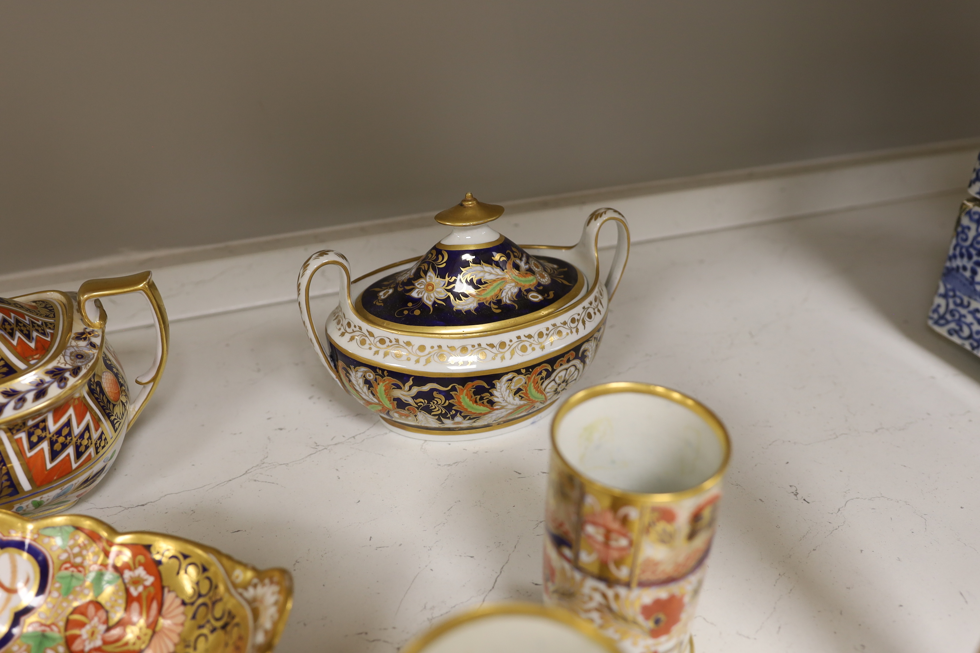 Sixteen mixed items of 1800-1820 English porcelain tableware, to include: three sucriers and covers, an oval ornately decorated dish, four saucer dishes, a candle holder, three spill vases and four saucers